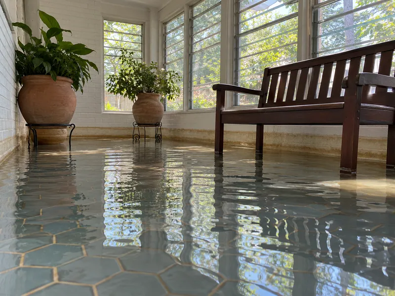 Water Extraction Near Mockingbird Nature Park — substantial standing water with clear waterlines and submerged lower furniture feet